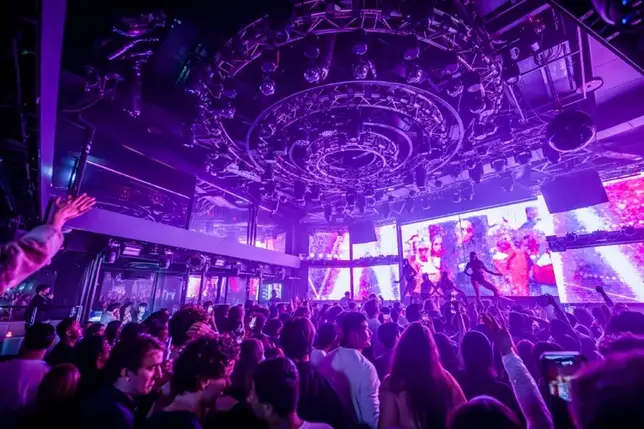 Inside WARP — packed main room under the light rig